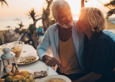 Senior couple having dinner at the beach